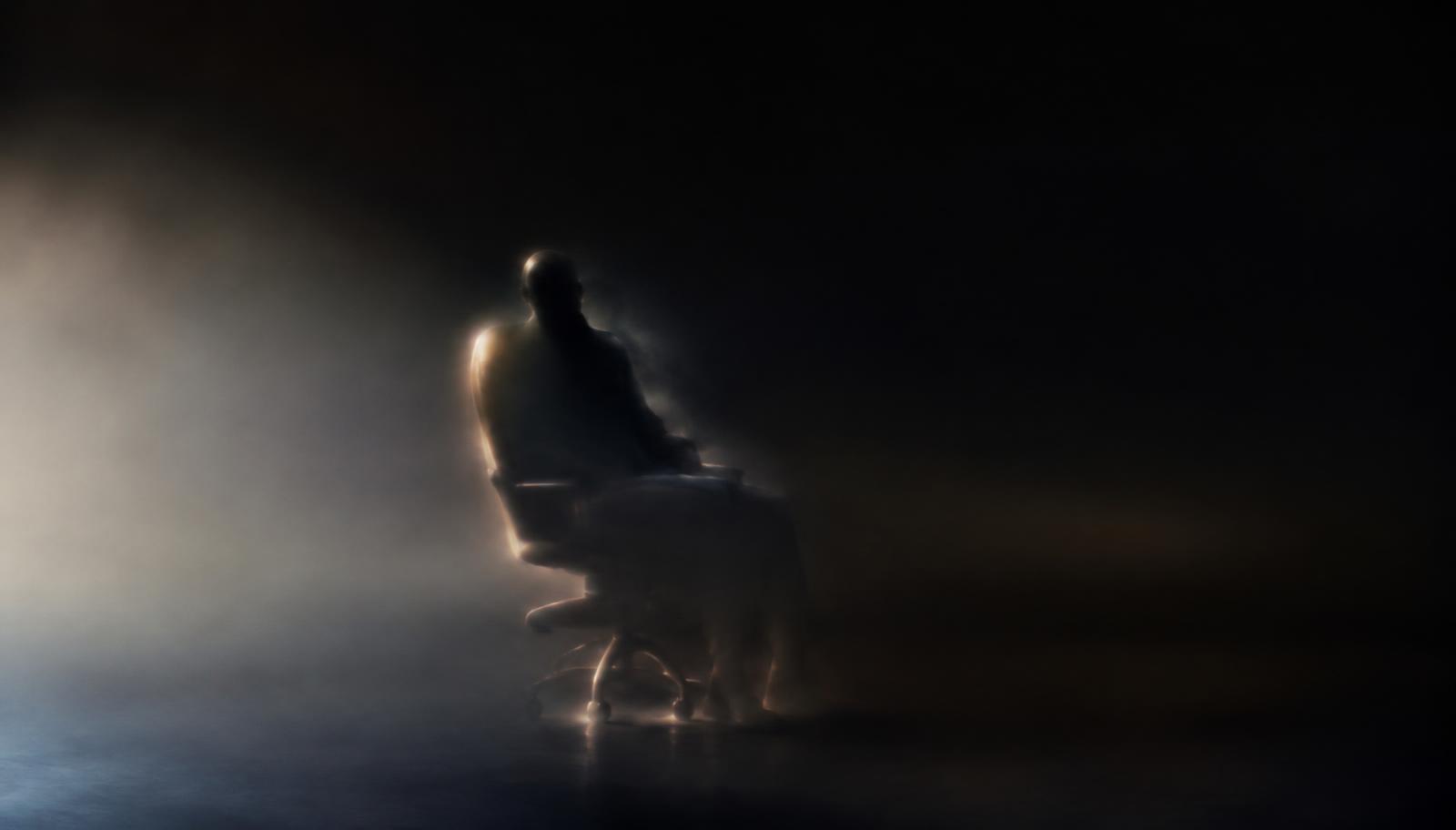Photorealistic surreal photography from the perspective of someone sitting upright after waking inside a dream, an indistinct seated silhouette and a faint office chair dissolving into a boundless dark void, almost no visible spatial boundaries, delicate peripheral light, realistic textures, quiet uncanny atmosphere, no text, no letters, no logos, no watermarks.
