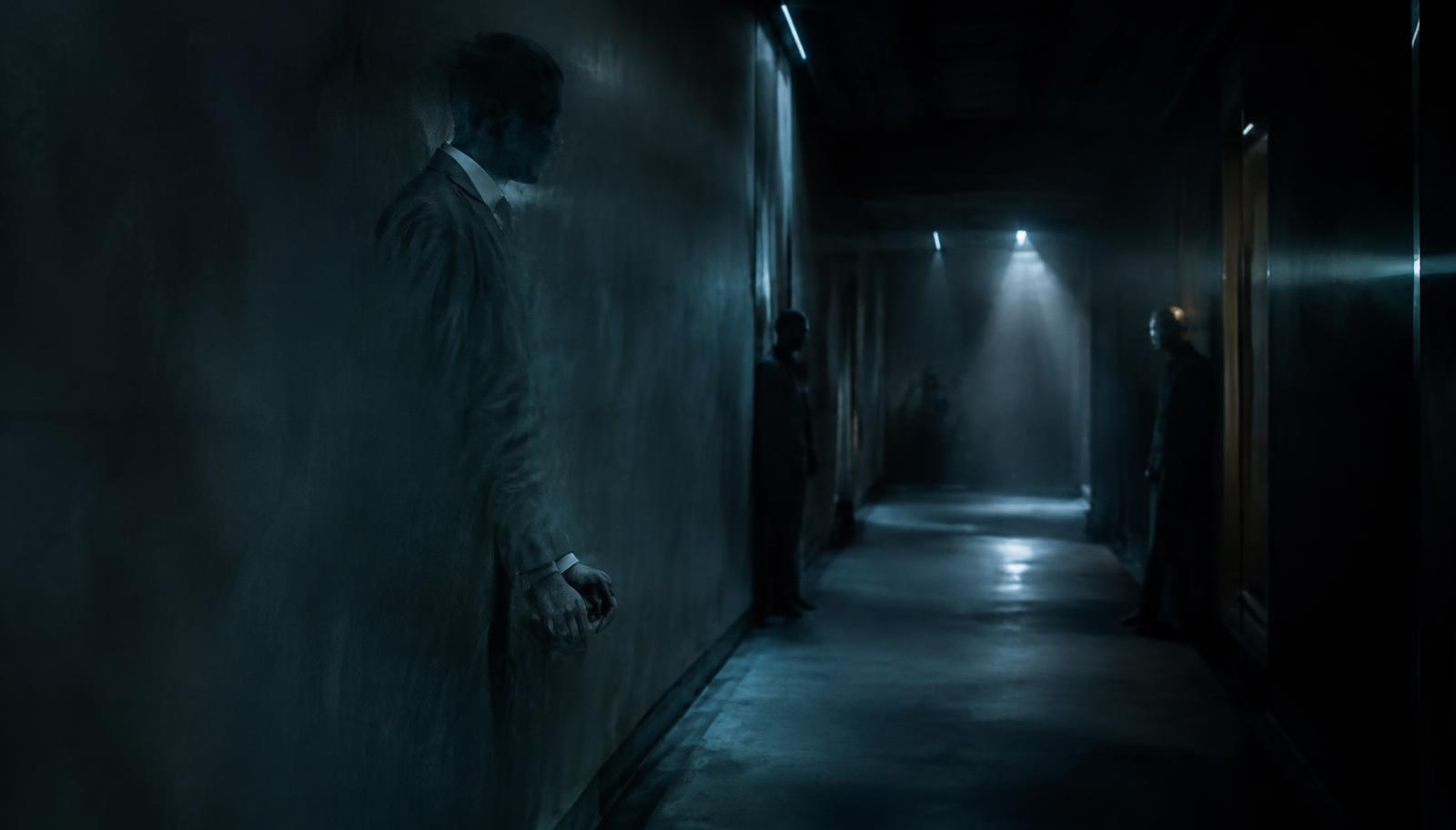 Photorealistic surreal photography of an anonymous figure partially blending into the walls of a dim corridor, several indistinct companions waiting at successive corners, subtle optical distortions suggesting invisible technology, cold cinematic lighting, realistic textures, tense dreamlike atmosphere, no text, no lettering, no logos.